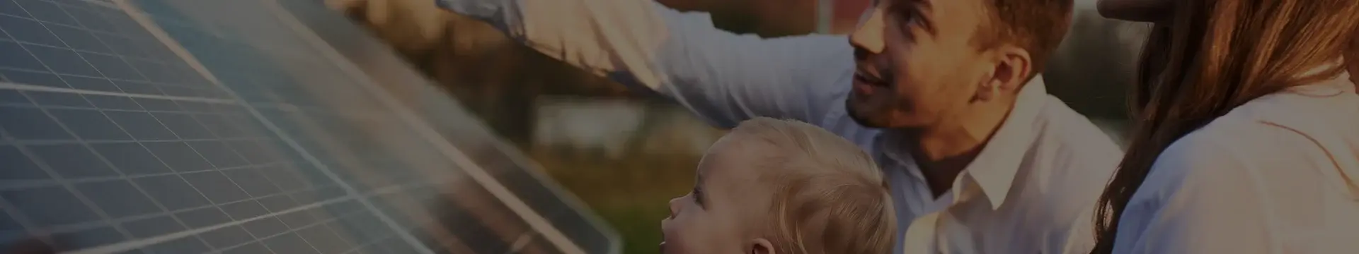 Man, woman and child close inspection of solar panels